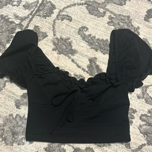 Cropped black top with puffy sleeves